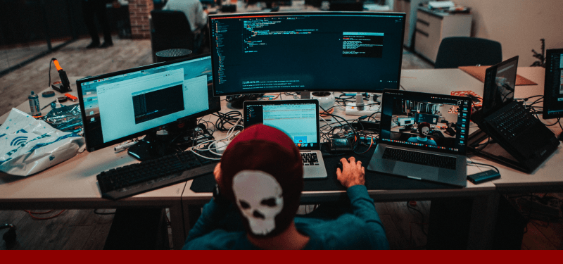 hacker behind computer